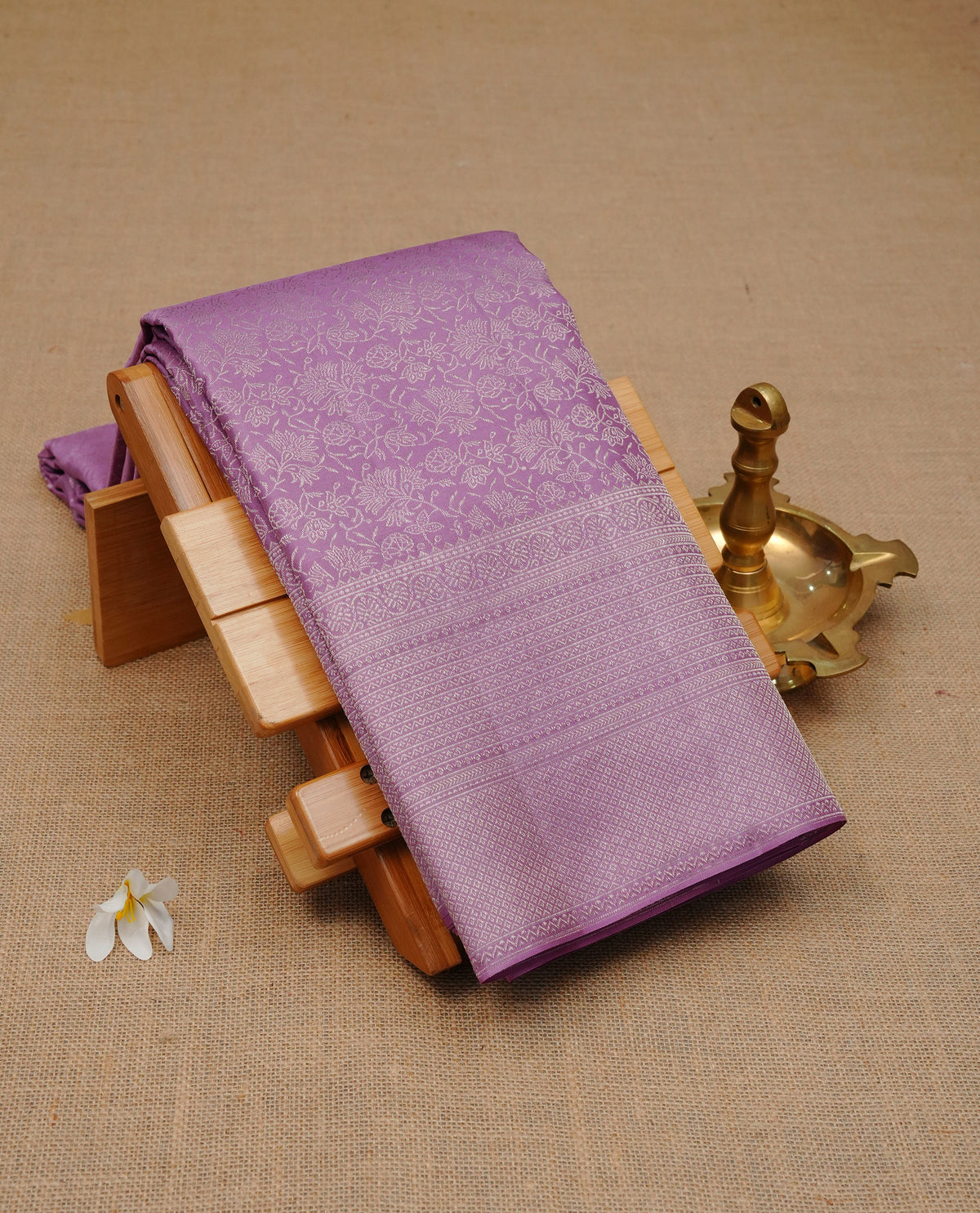 Lavender colour pure wedding silk saree featuring Silver zari Floral kodi pattern on body, complemented by self colour with traditional border, comes with matching blouse piece.