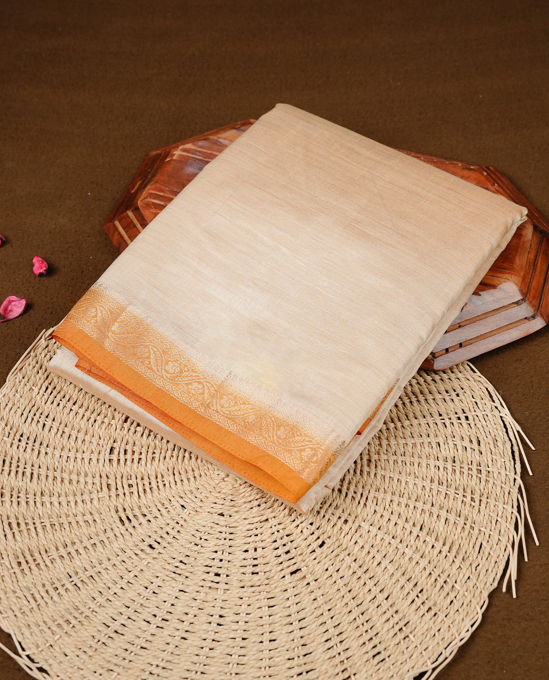 Cream colour Semi Tussar silk saree featuring an elegant plain body, accentuated by a contrast Mustard border adorned with intricate gold floral kodi zari work, paired with a matching blouse piece.
