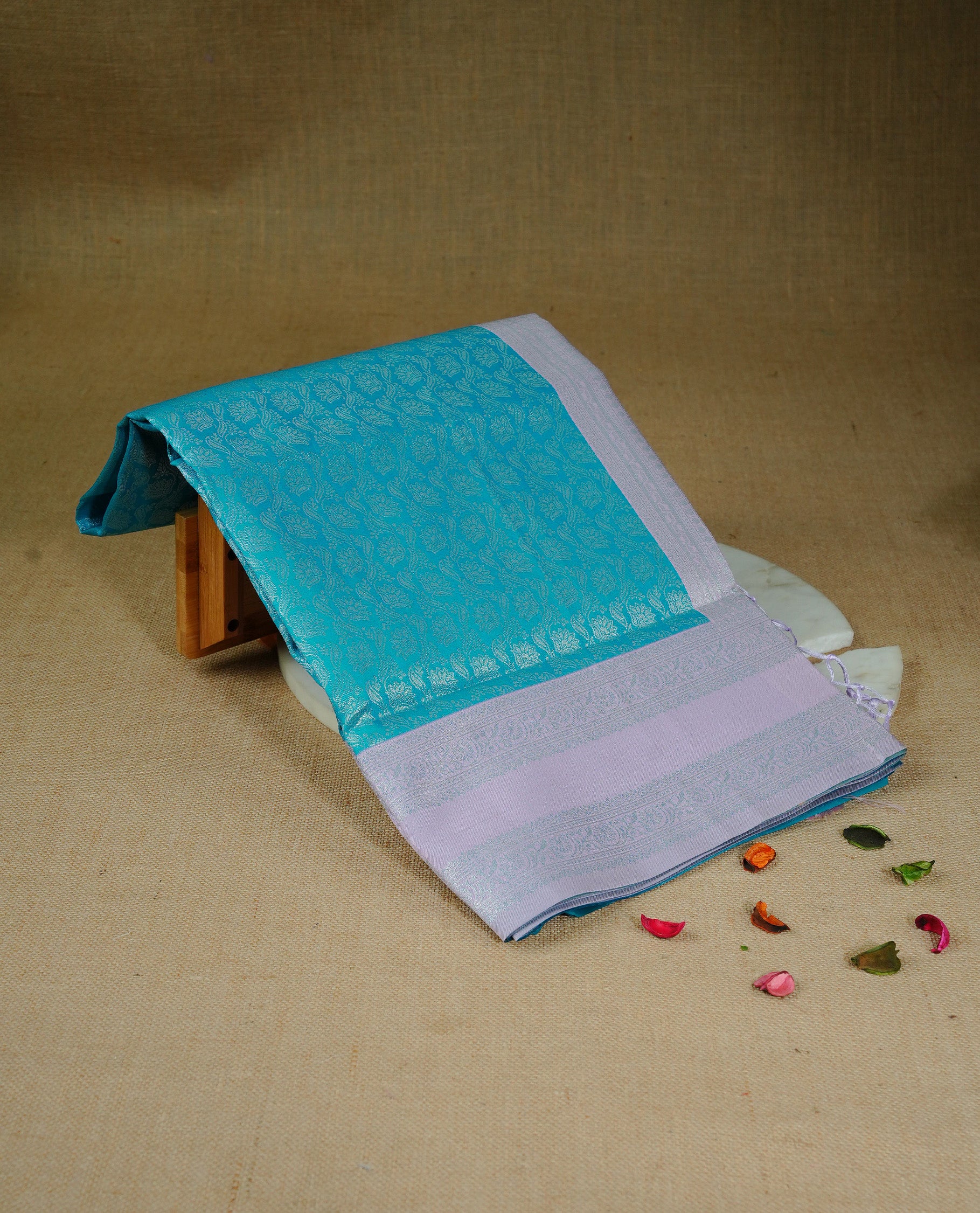Aqua colour semi silk saree featuring Silver zari Floral pattern on body, complemented by contrast Lavender colour with silver zari border, comes with matching blouse piece.