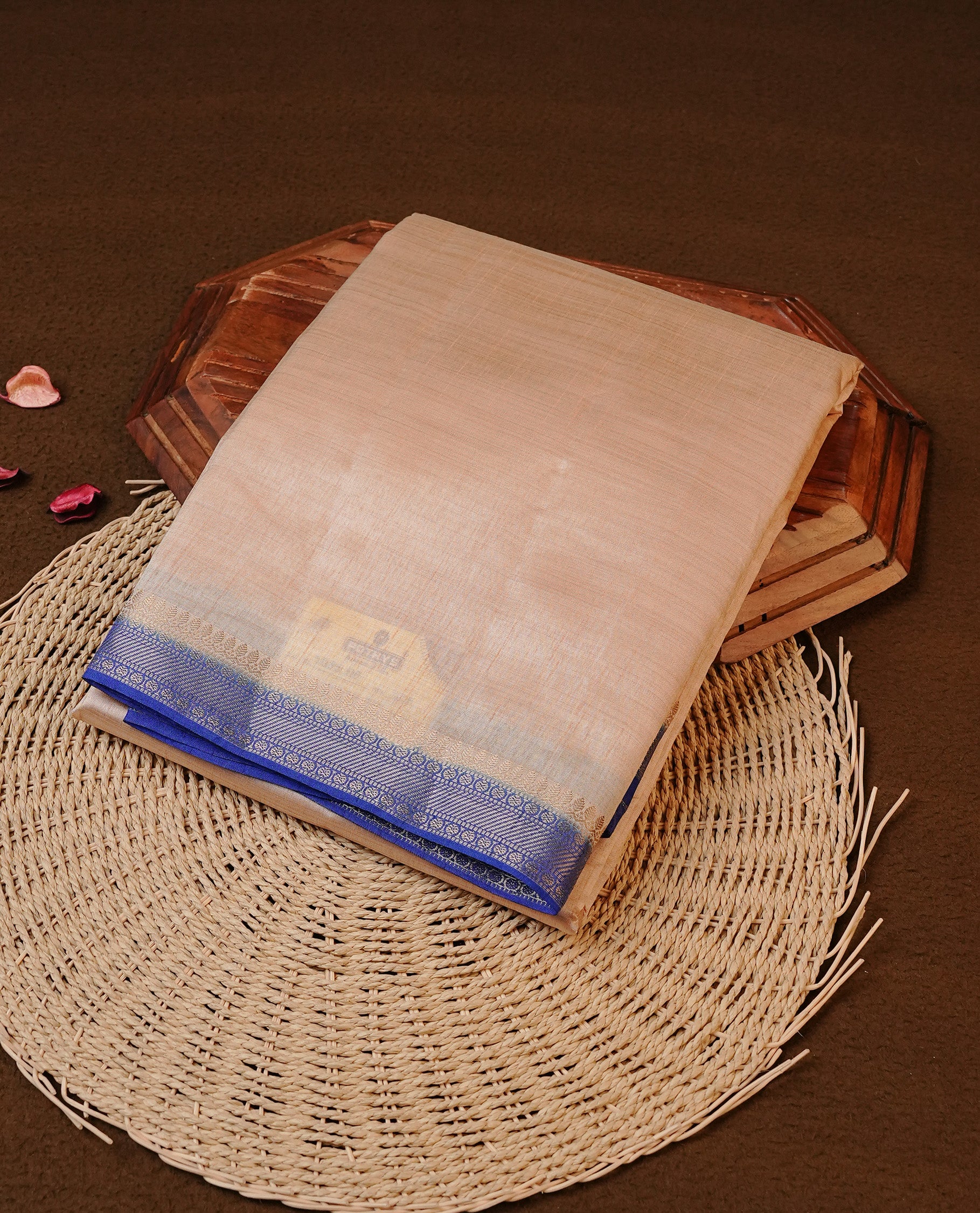 Cream colour Tussar silk saree Featuring Elegant Plain body, complemented by Contrast Blue colour with gold zari border, paired with matching blouse piece.
