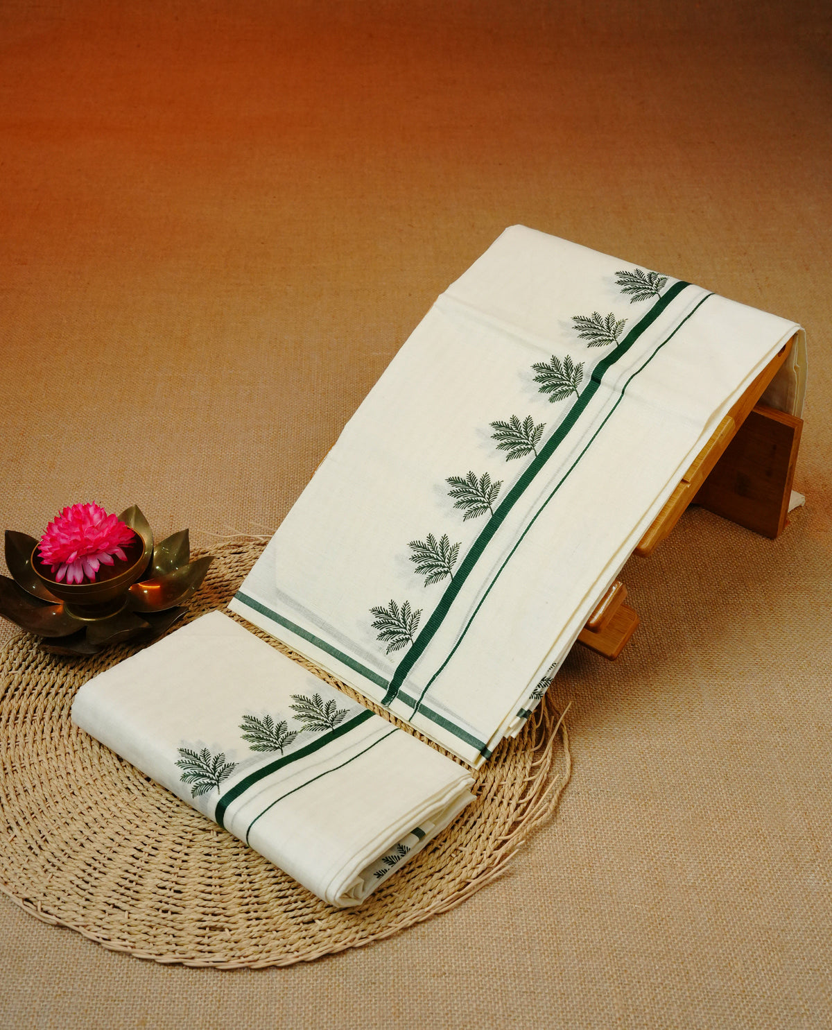 Cream colour cotton set mundu featuring green kara with leaf print.