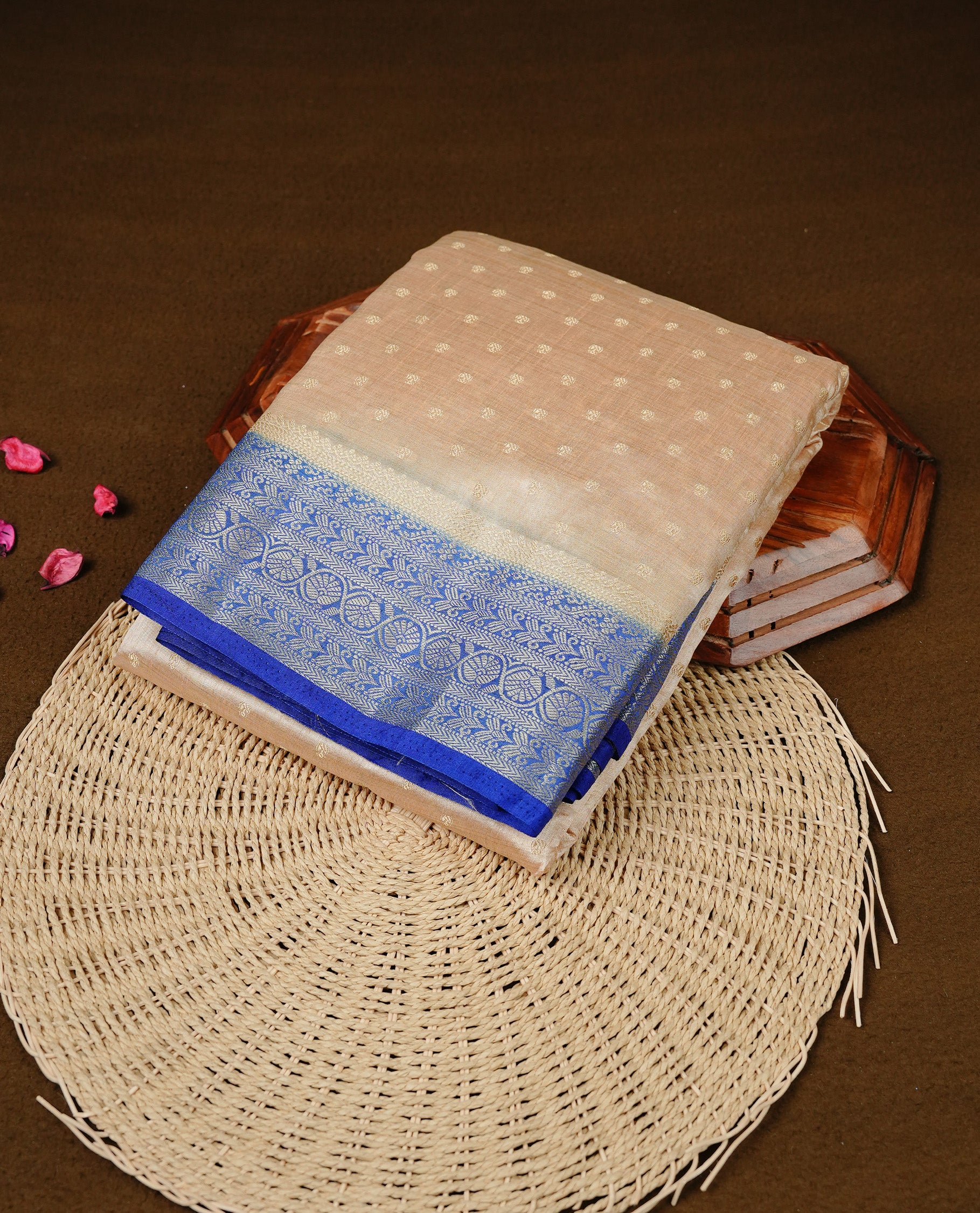 Cream colour Semi Tussar silk saree featuring an Gold zari motifs on body, accentuated by a contrast Blue border adorned with intricate gold zari work, paired with a matching blouse piece.