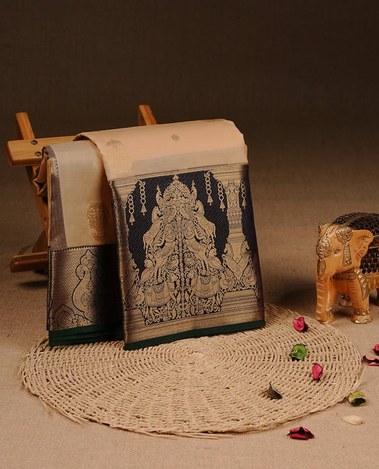 Cream colour Traditional Kancheepuram silk saree featuring gold zari motifs on body, enhanced with contrast Black with traditional border with green piping, paired with matching blouse piece.