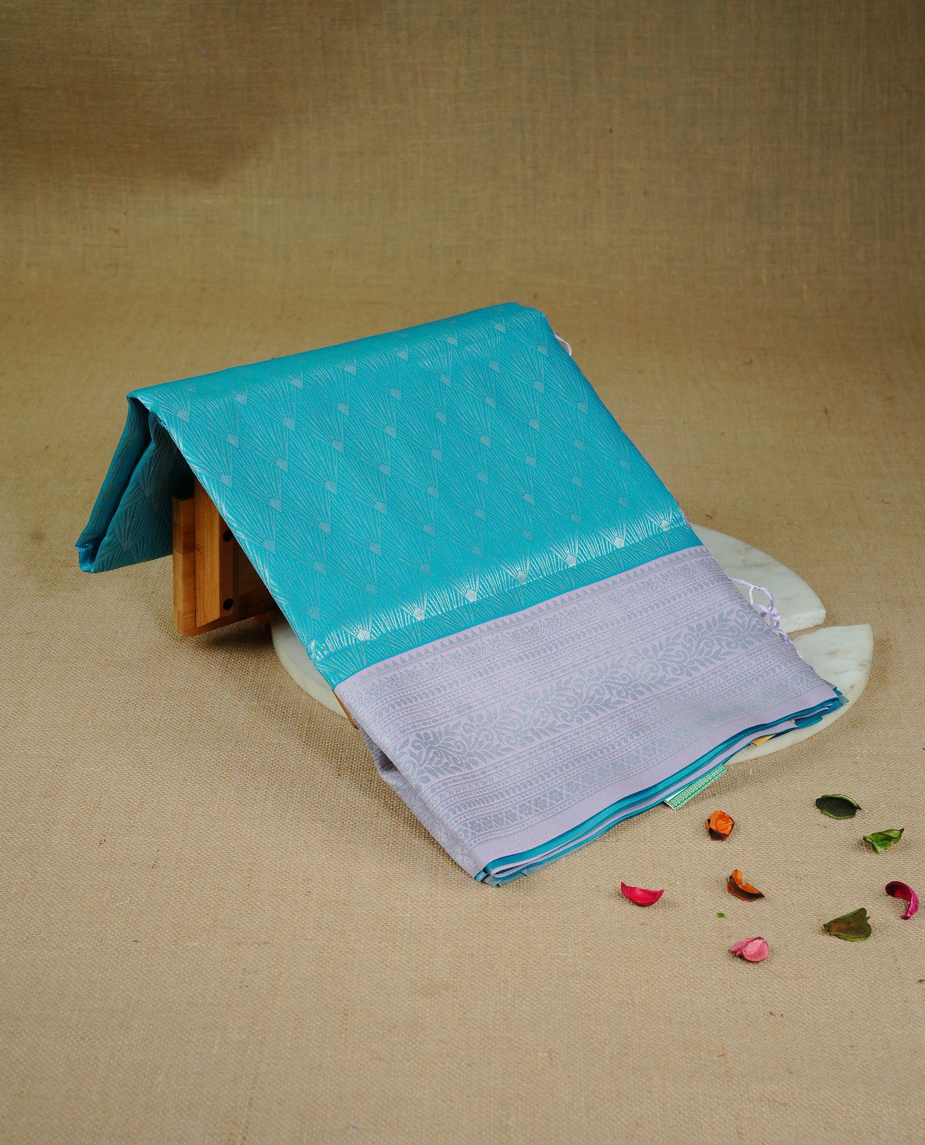 Aqua colour semi silk saree featuring Silver zari Design pattern on body, complemented by contrast Lavender colour with silver zari border, comes with matching blouse piece.