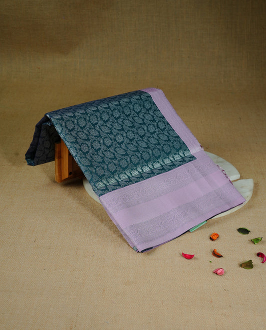 Green colour semi silk saree featuring Silver zari pattern on body, complemented by contrast Pink colour with silver zari border, comes with matching blouse piece.