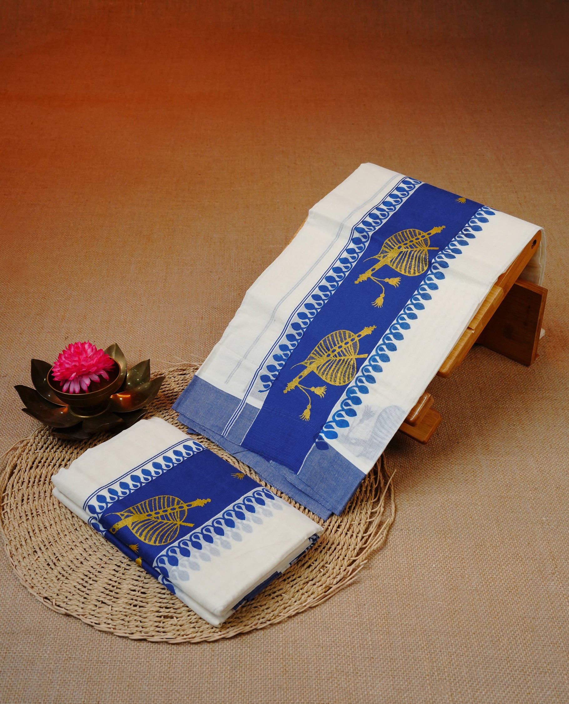Cream colour cotton set mundu featuring Blue kara with Gold Leaf with flute print.
