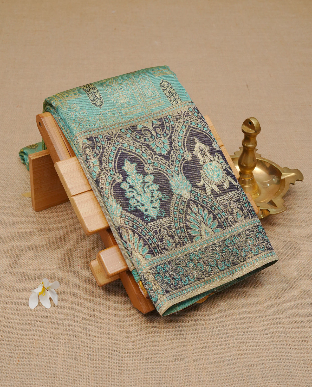 Light sea green colour samudrika silk saree featuring Gold zari Panel Pattern on body, complemented by contrast Brown colour with traditional on border, comes with matching blouse piece.