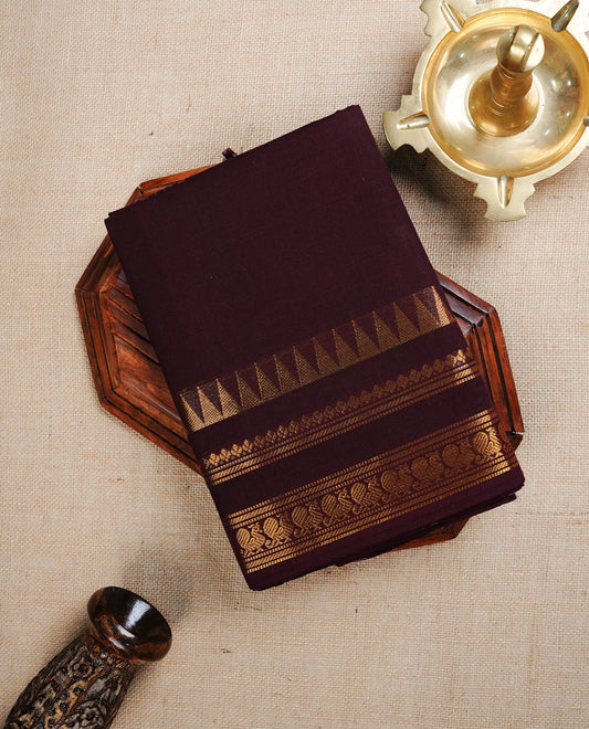 Dark chocolate Colour chettinad cotton saree featuring Elegant plain body, complemented by self colour with Gold zari border, paired with matching blouse piece.