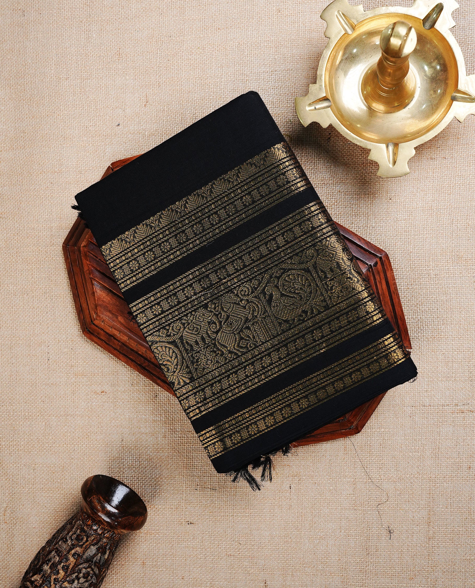 Black colour chettinad cotton saree featuring  Plain body, complemented by  Grand Gold Zari border, paired with matching blouse piece.