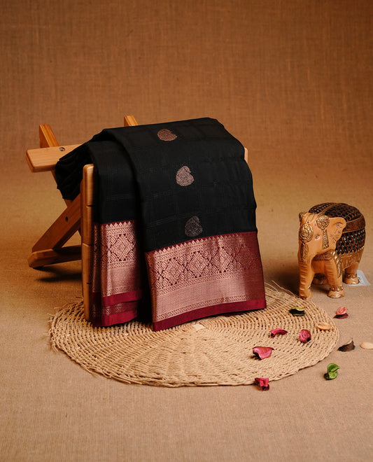 Black Colour Traditional Kancheepuram Silk  Saree Featuring Black Check  Gold Zari Mango Motifs on the Body, Complemented by a Contrast Maroon Colour Gold Zari Traditional Border and Pallu, Paired with a Matching Blouse .