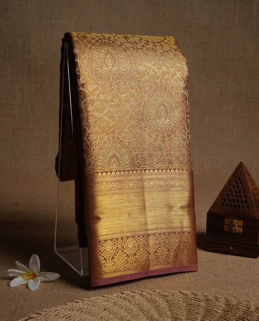 Pinkish beige & goldcolour kancheepuram tissue silk saree highlighting gold floral zari pattern body, with contrast Pinkish beige colour colour with traditional border and paired with matching blouse.
