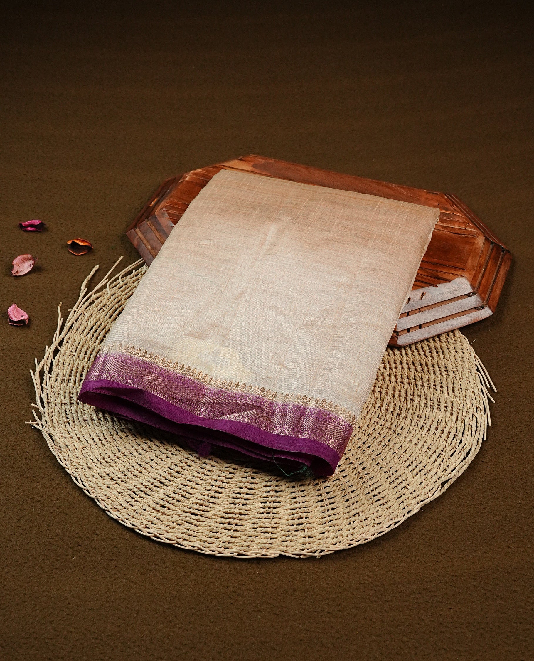 Light gold Colour Tussar saree featuring elegant plain body, complemented by contrast Purple colour with zari work border, comes with matching blouse piece.