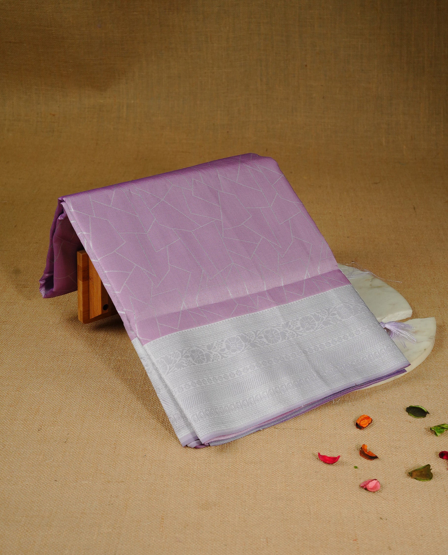 Light purple colour semi silk saree featuring Silver zari Geometric pattern on body, complemented by contrast Lavender colour with silver zari border, comes with matching blouse piece.