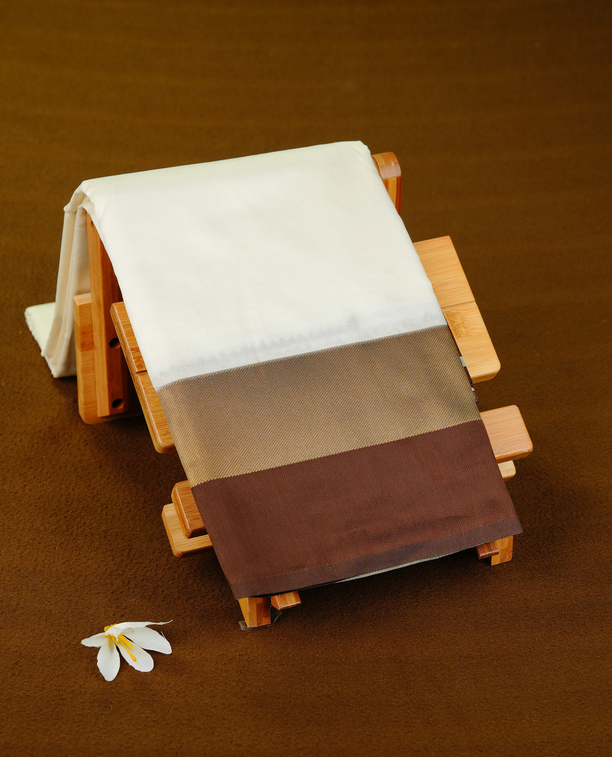 Off White colour soft silk saree with contrast Chocolate border.
