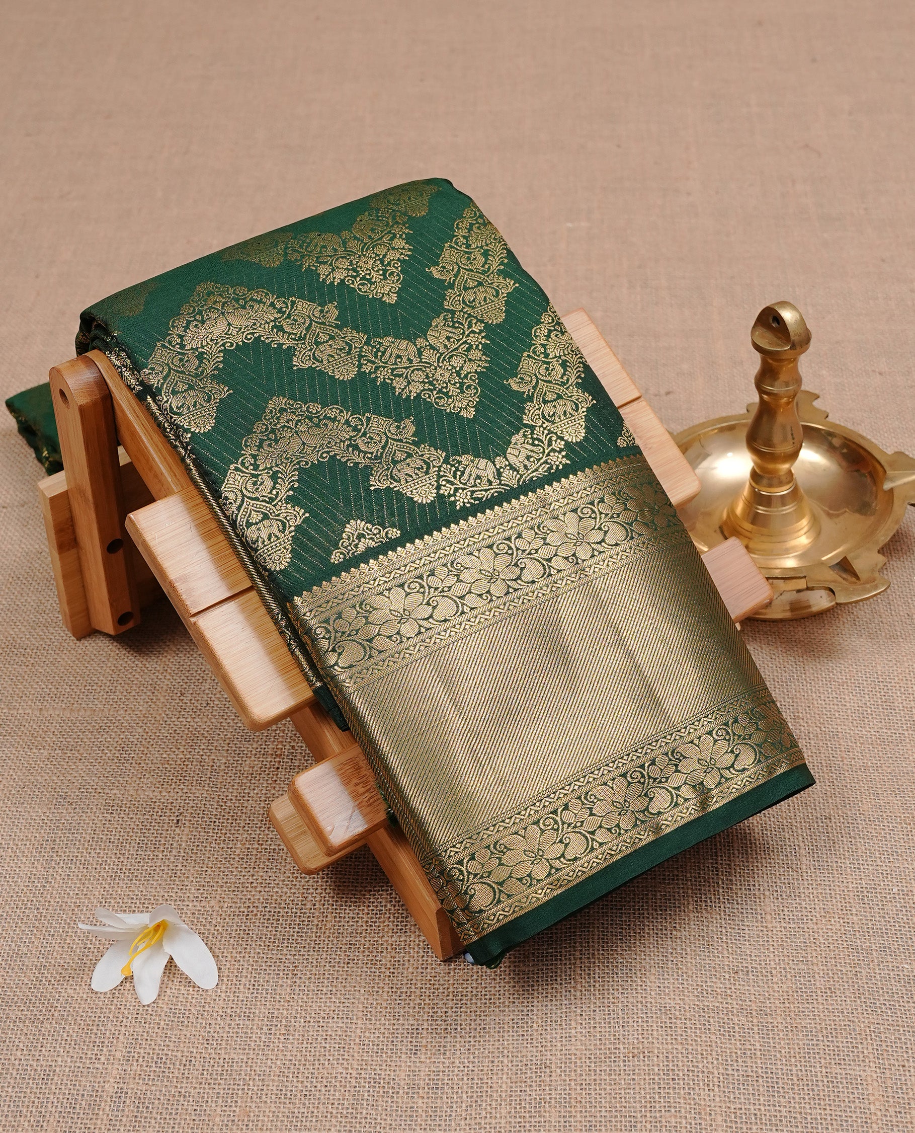 Bottle green Semi Wedding Silk Saree featuring Gold Zari zigzag pattern On body, Complemented with traditional zari with Self colour border, paired with matching blouse piece.