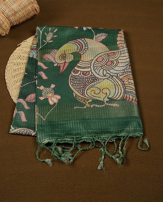 Green colour semi tussar silk saree featuring intricate peacock motifs on the pallu, subtle zari check pattern across the body, floral vine prints throughout, finished with tassels and paired with a matching printed blouse piece.
