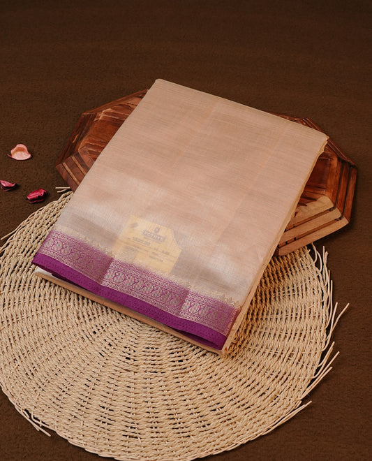 Cream colour Tussar silk saree Featuring Elegant Plain body, complemented by Contrast Purple colour with gold zari border, paired with matching blouse piece.