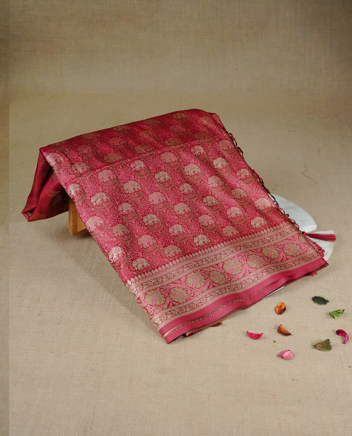 Red colour Mulberry silk saree featuring gold zari elephant & floral kodi pattern across body, complemented by self colour border with gold & orange zari work, comes with matching blouse piece.