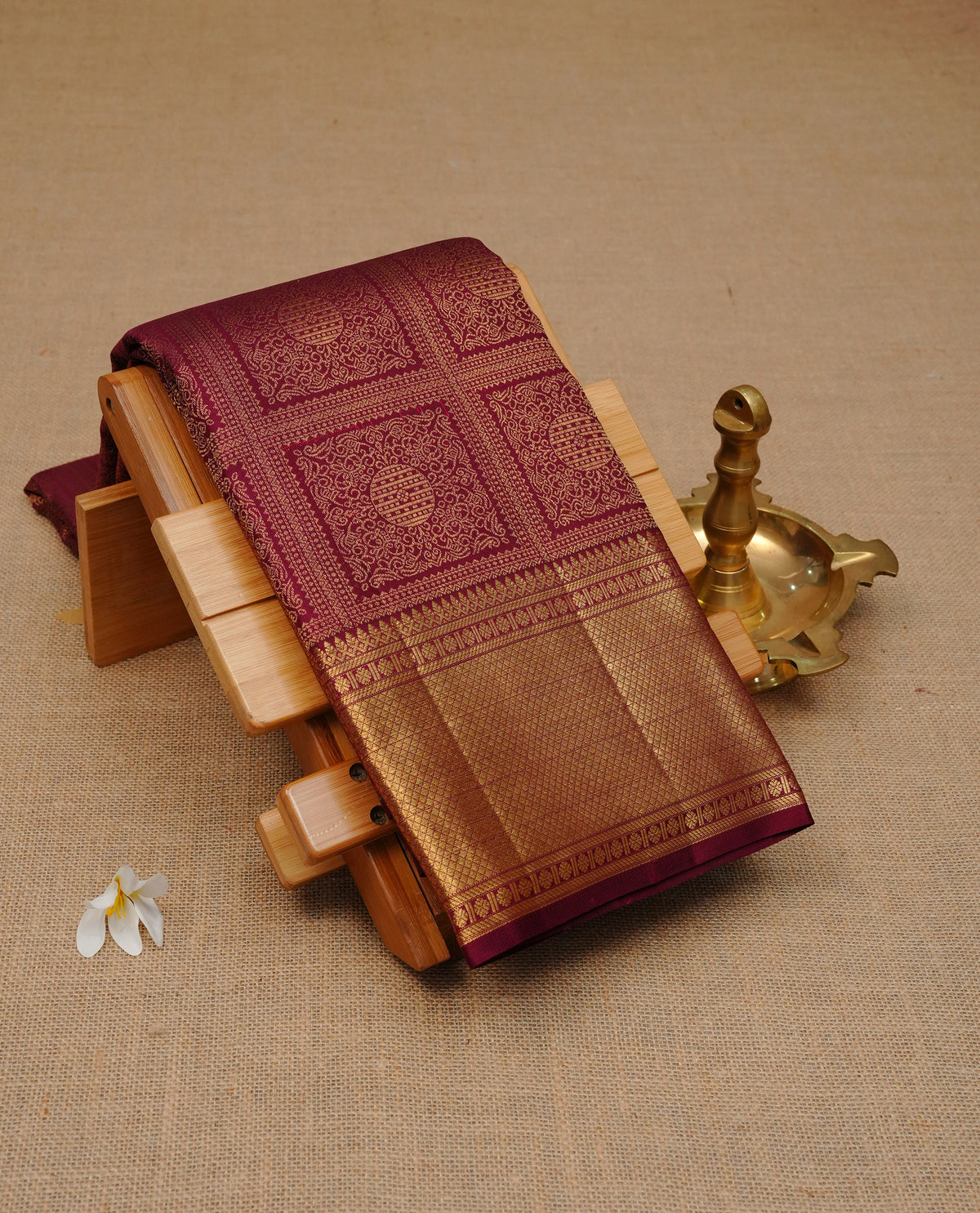 Maroon Colour Pure Wedding silk saree featuring Gold zari Box with with kodi pattern with circle motif worked body, complemented by self colour with traditional border, comes with matching blouse piece.