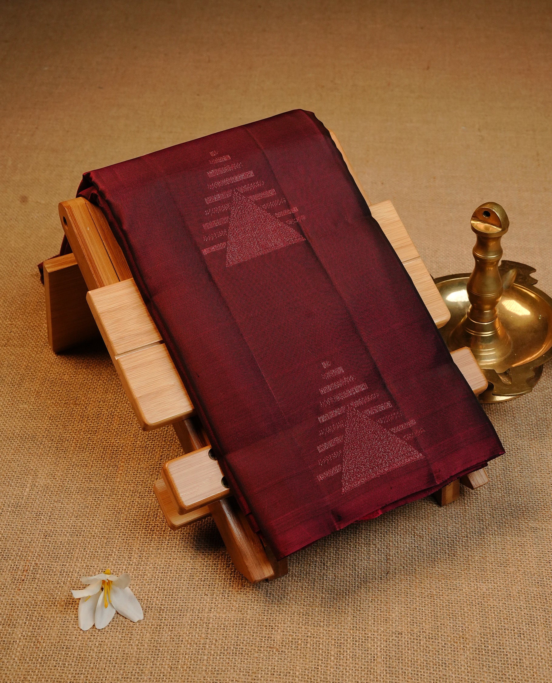 Wine Colour Traditional Kancheepuram Silk Saree Featuring Light Gold  Zari Triangle  Motifs on the Body, Designed Without a Border and with a Grand Pallu, Paired with a Matching Blouse.