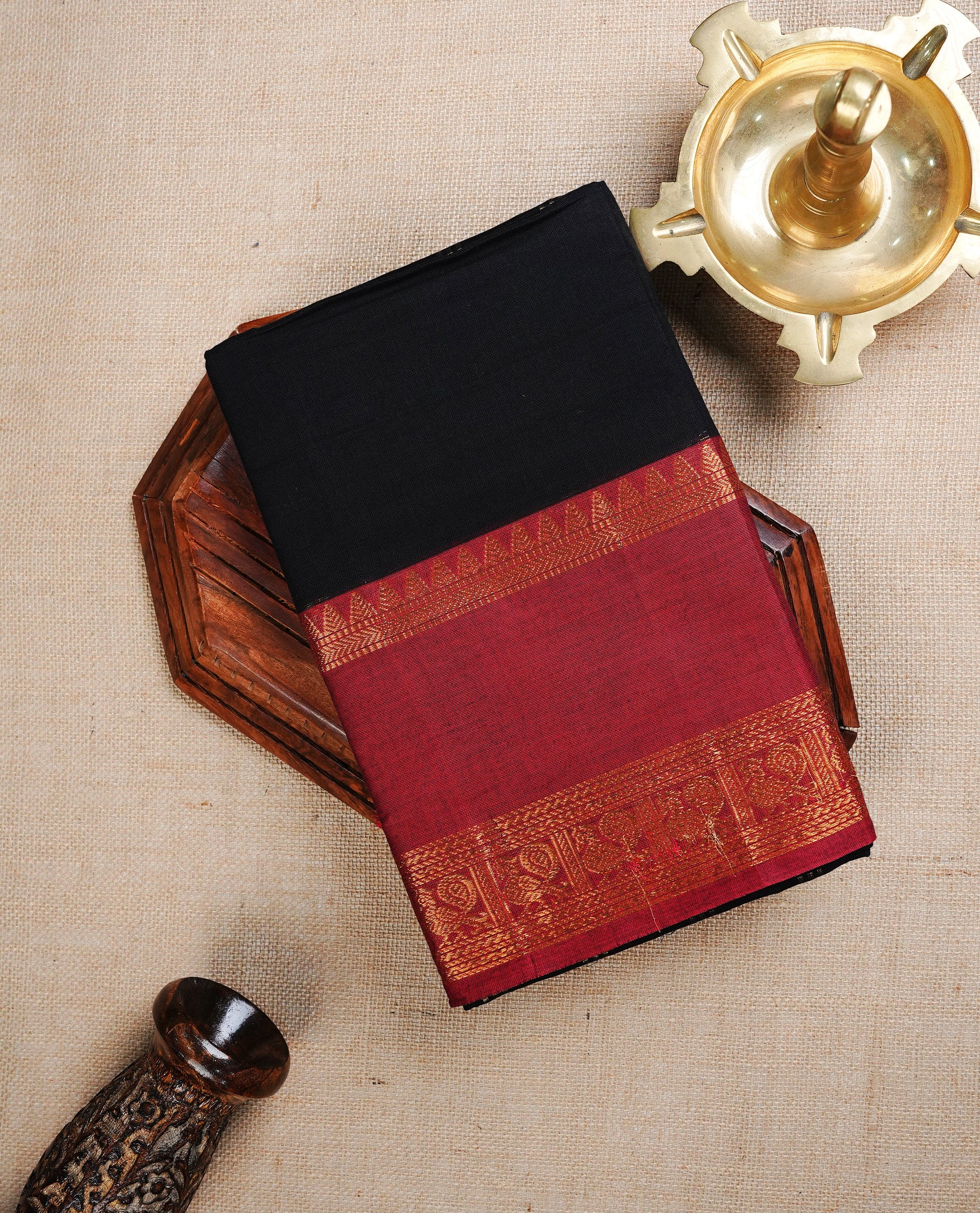 Black colour chettinad cotton saree featuring  a Plain  body, complemented by Contrast  Red Colour With Gold Zari border, paired with matching blouse piece.