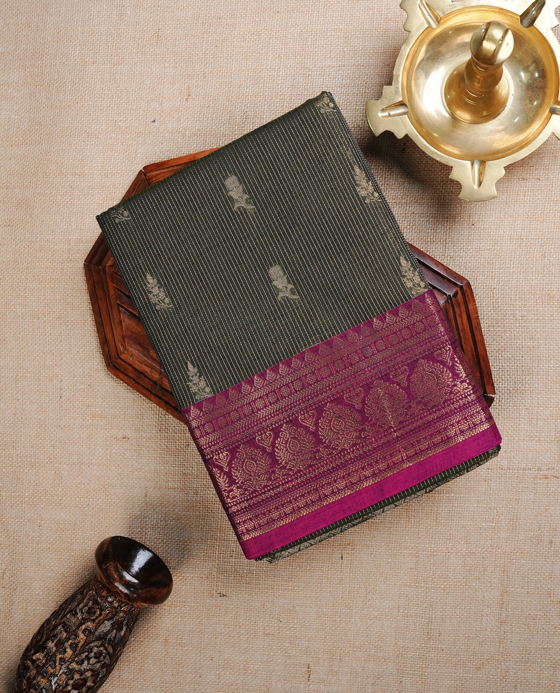 Green colour chettinad cotton saree featurign gold zari stripes pattern with Motifs on body, complemented by contrast Magenta With gold zari border, paired with matching blouse piece.