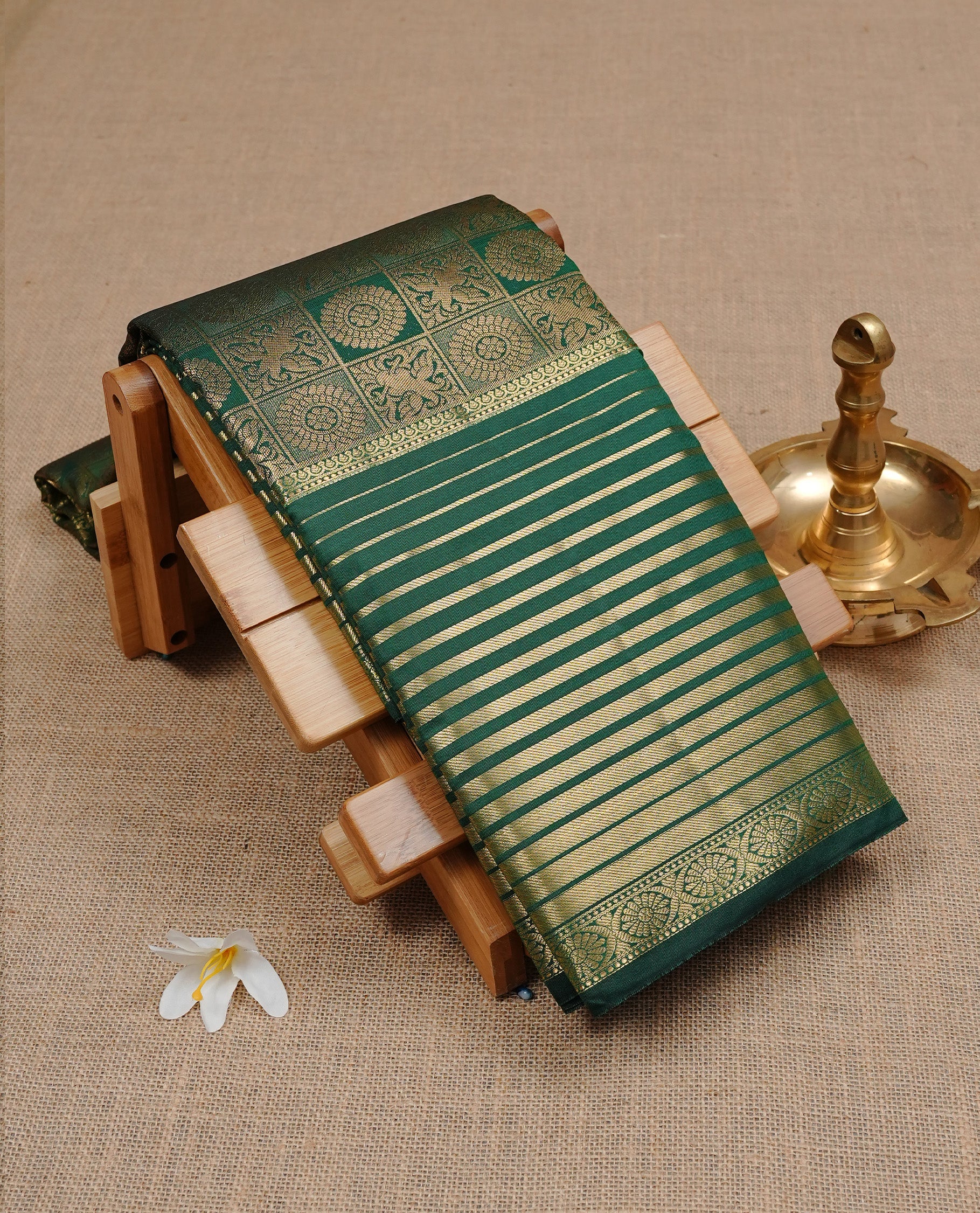 Green Semi Wedding Silk Saree featuring Gold Zari Box with Motifs On body, Complemented with traditional zari with Self colour border, paired with matching blouse piece.