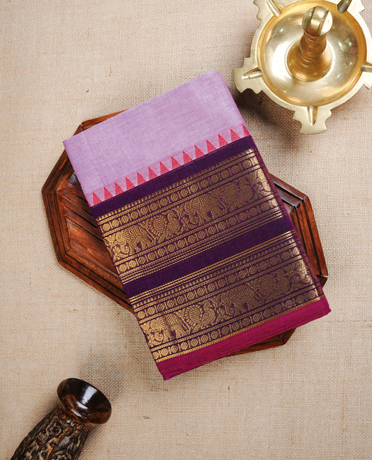 Lavender colour Chettinad cotton saree featuring Elegant plain body, complemented by contrast Purple colour with Gold zari border, paired with matching blouse piece.