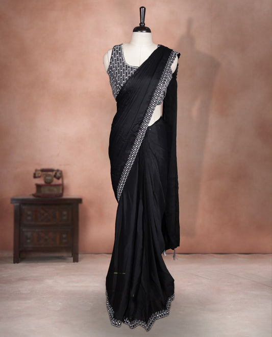 Elegant Black colour ready to wear saree adorned with rich silver stone and bead embroidery along the border and pallu, paired with a heavily embellished matching blouse for a grand festive look.