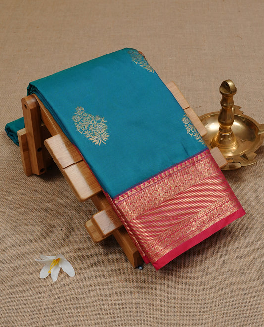 Peacock colour semi Wedding silk saree featuring Gold zari motifs on body, enhanced with Contrast red colour with traditional border, paired with matching blouse piece.