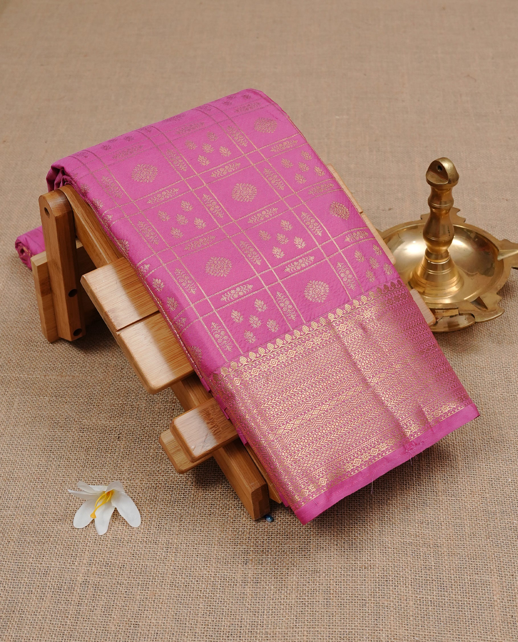 Pink Semi Wedding Silk Saree featuring Gold Zari Check with Motifs On body, Complemented with traditional zari with Self colour border, paired with matching blouse piece.