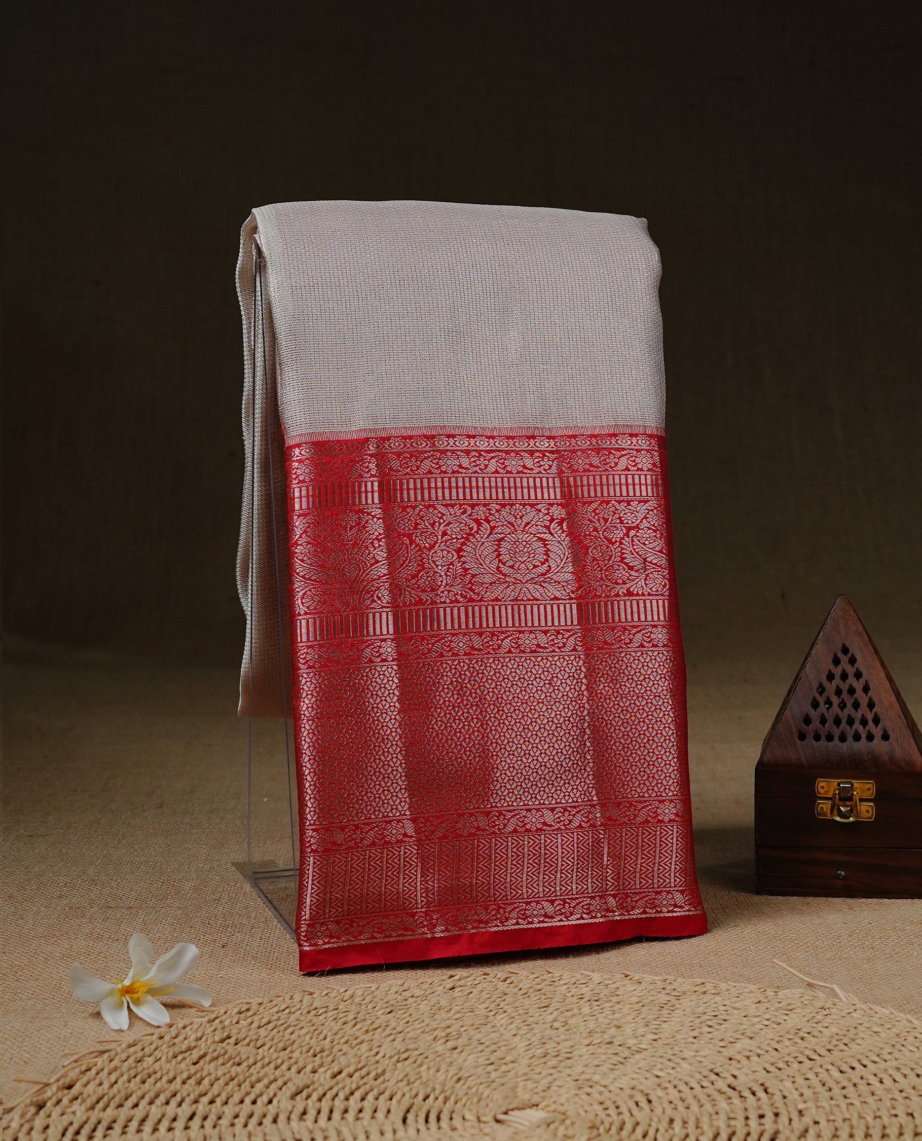 Off white colour Net Tissue saree Elegant plain body, complemented by Red colour with Light gold zari long traditional border, paired  with matching blouse piece.