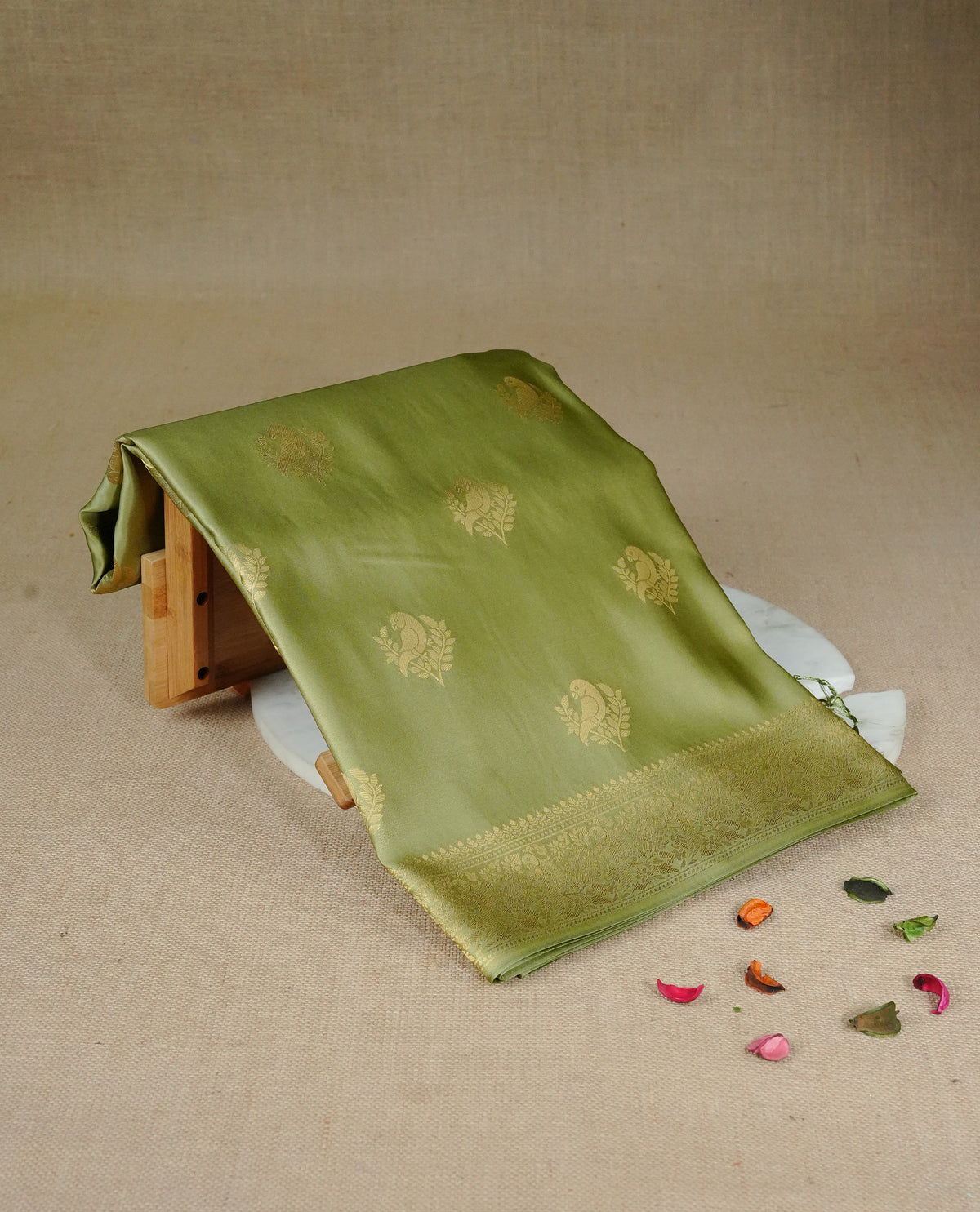 Pastel green colour Mulberry silk saree featuring Gold zari bird motifs on body, complemented by self colour with gold zari border, comes with matching blouse piece.