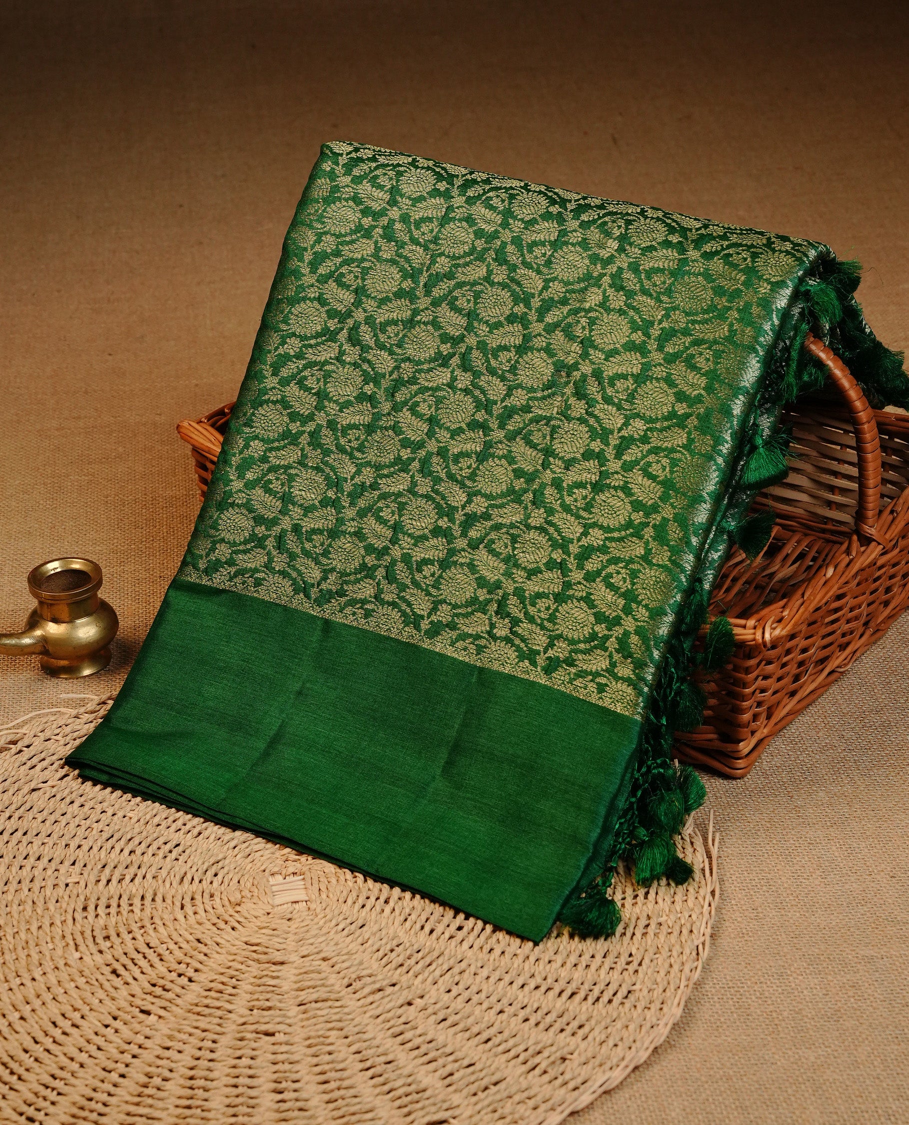 Green  colour pure tussar silk saree featuring light gold zari floral kodi work on the body, a plain border, grand pallu, Paired With  a matching blouse piece.