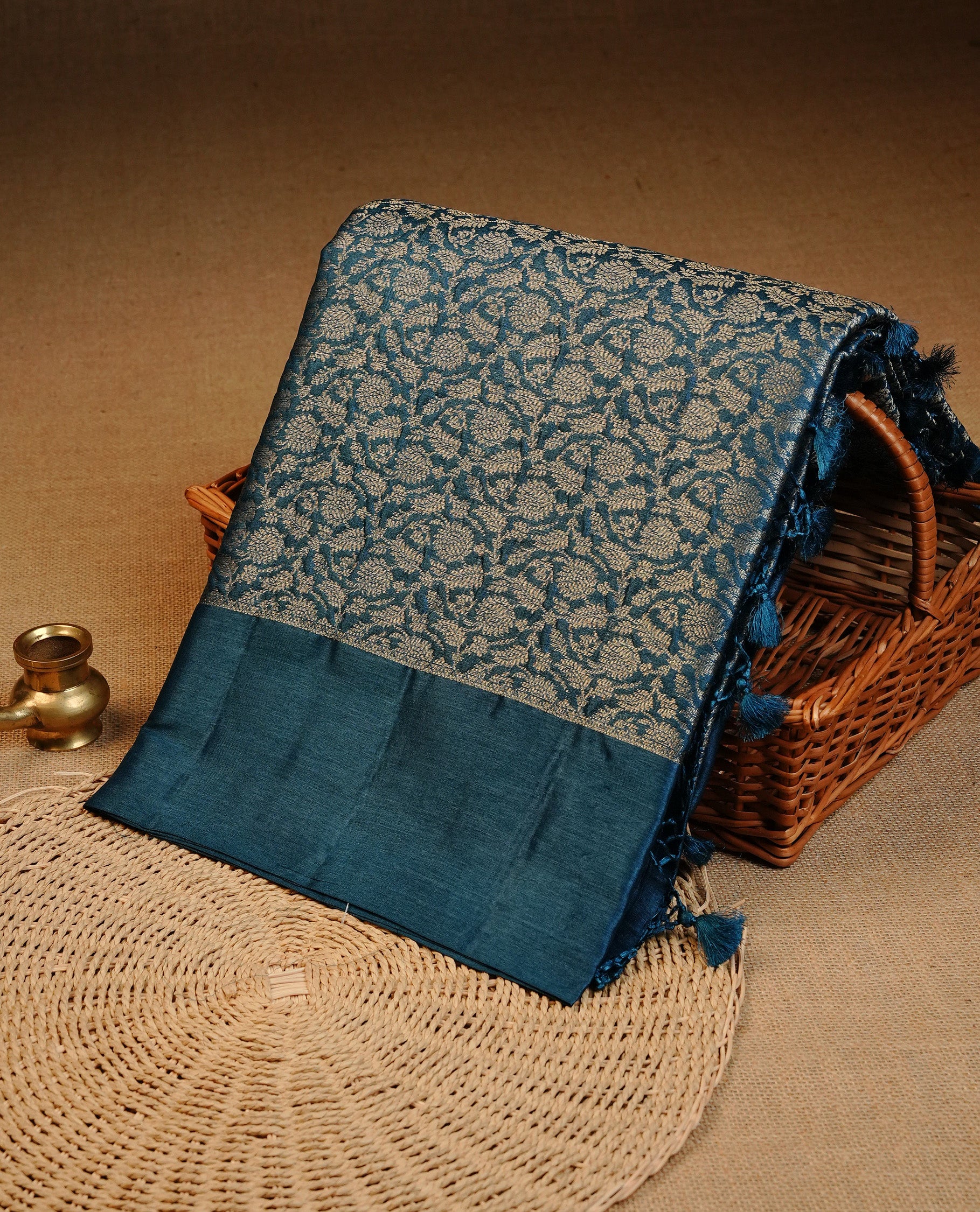 Teal Blue  colour Pure tusser silk saree featuring Silver  Zari floral Kodi Work On Body , A Plain  border & Grand  pallu ,Paired With  a matching blouse piece.