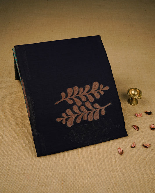 Navy blue colour semi linen saree with elegant gold zari leaf motifs across the body, complemented by a contrast peacock green pallu and a borderless design, paired with a matching blouse piece.