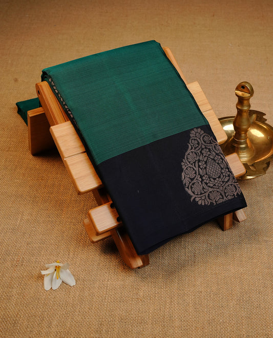 Peacock Green  colour soft silk saree featuring Plain body, complemented by contrast Blue with Rose Gold Zari   border, paired with matching blouse piece.