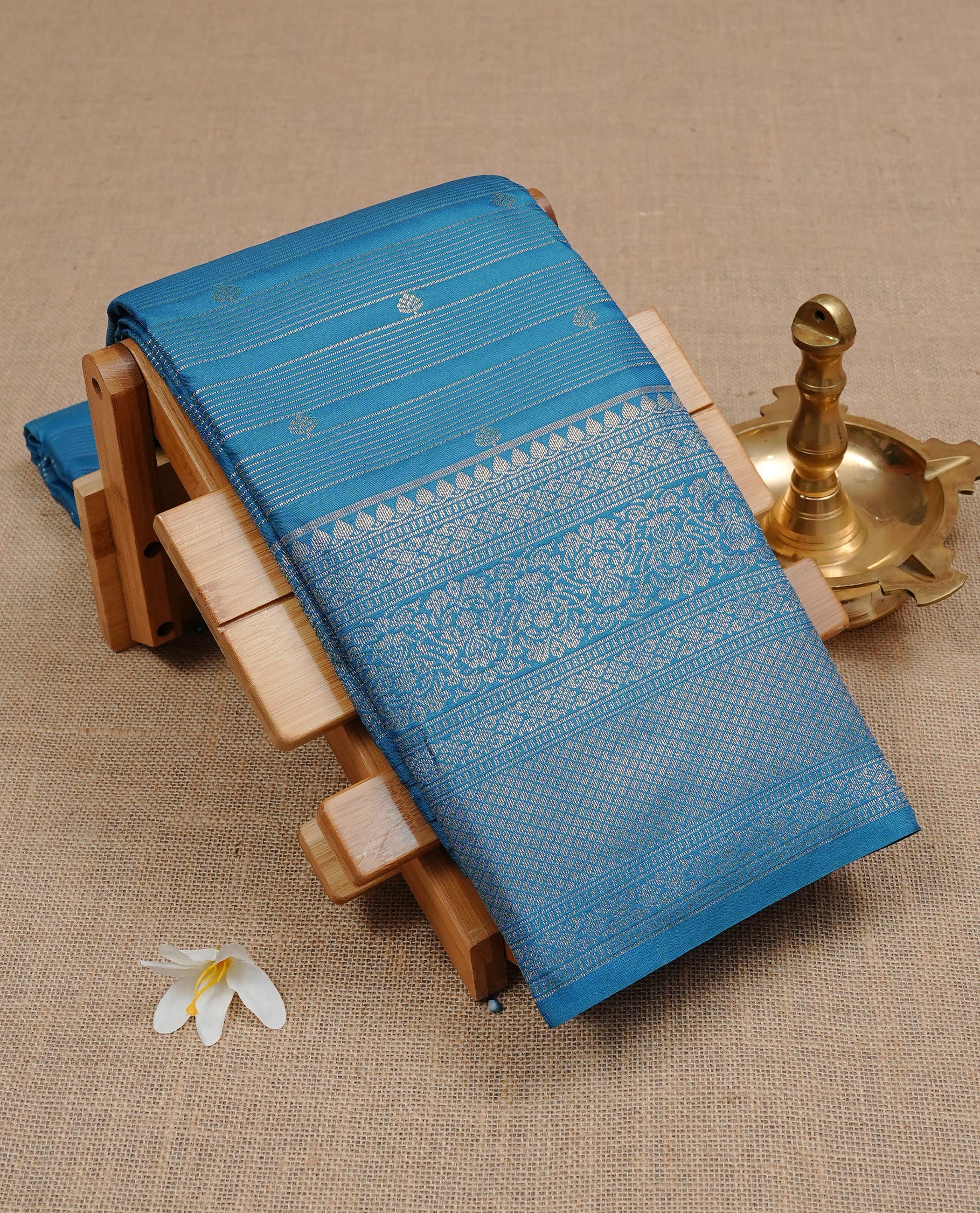 Aqua Colour Wedding Silk Saree Featuring Gold zari Strip pattern on body, complemented by traditional Zari pattern on self colour border, paired with matching blouse piece.