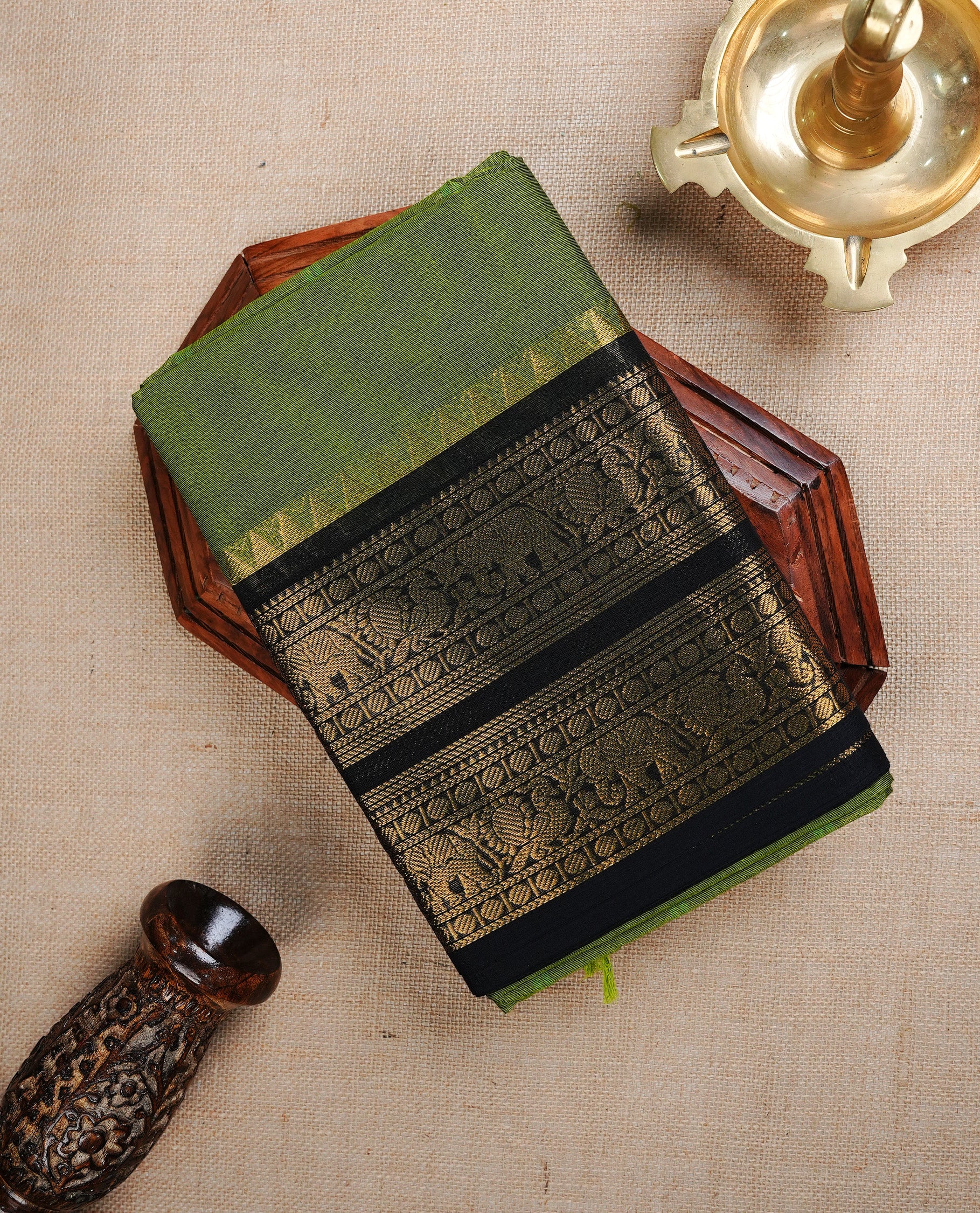 Green colour Chettinad cotton Featuring elegant plain body, complemented by contrast Black colour with gold zari border, paired with matching blouse piece.