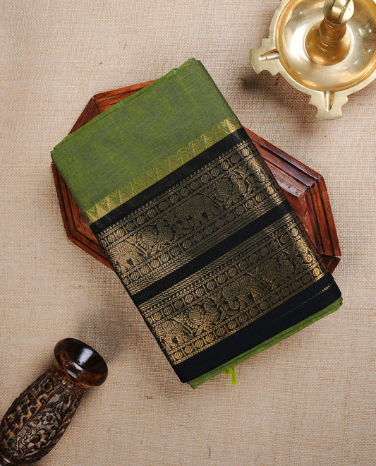 Green colour Chettinad cotton Featuring elegant plain body, complemented by contrast Black colour with gold zari border, paired with matching blouse piece.