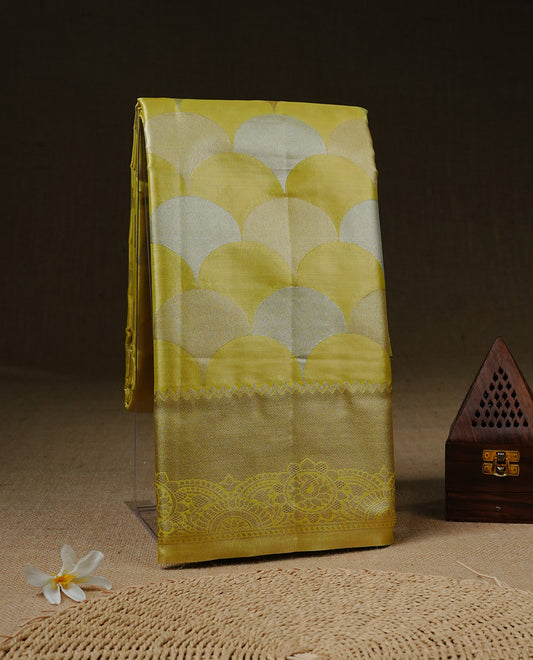 Yellow colour Tissue saree Featuring yellow, Gold, silver zari Scales design on body, complemented by traditional border on self colour, paired with matching blouse piece.