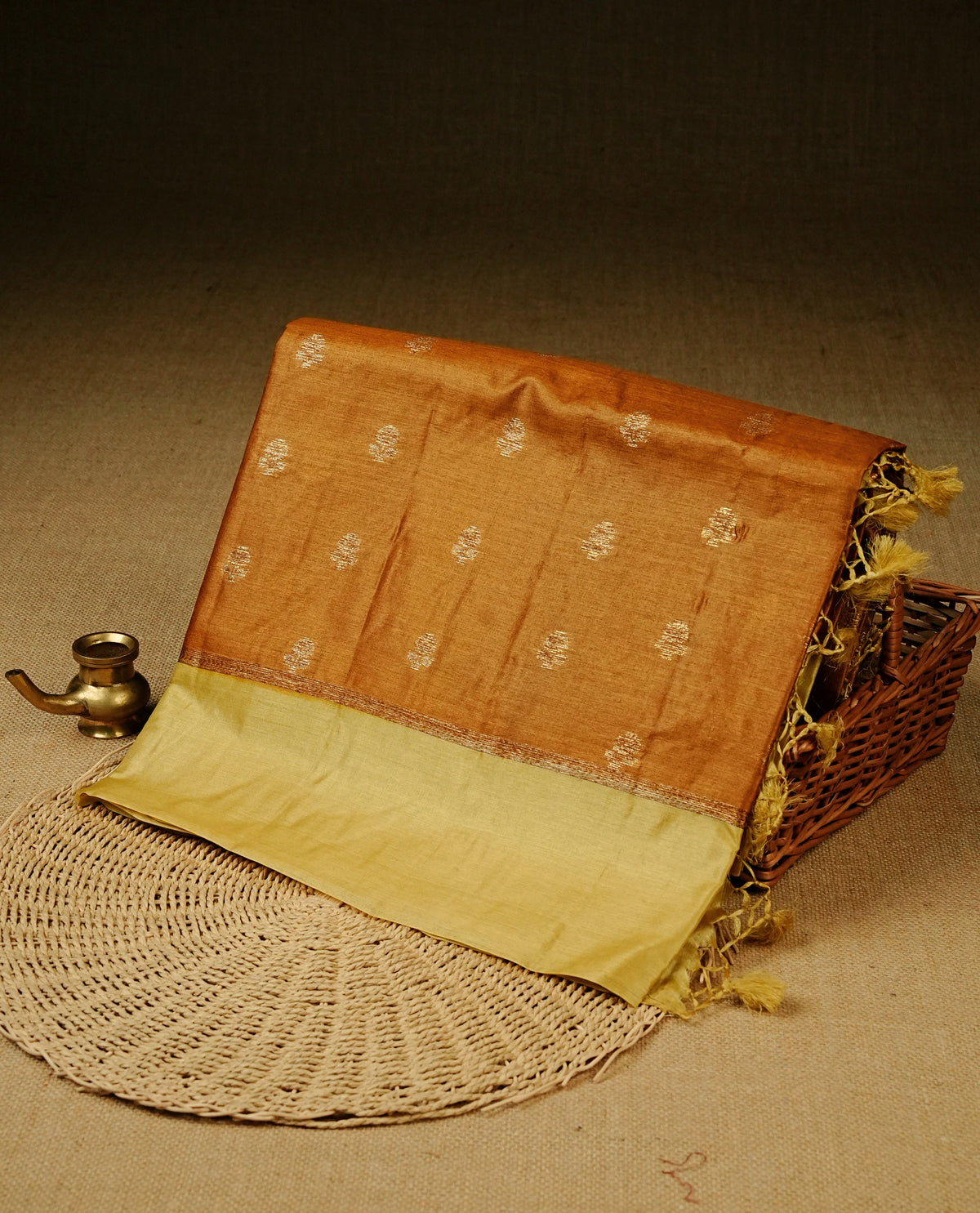 Dark mustard colour banaras silk saree featuring Gold zari buttas on body, complemented by contrast Pale yellow colour border, comes with matching blouse piece.