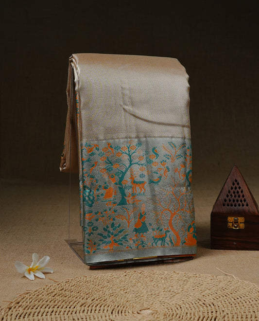 Golden colour Tissue Silk Saree features intricate tree Motifs on body and fancy border & pallu with floral patterns, paired with matching blouse