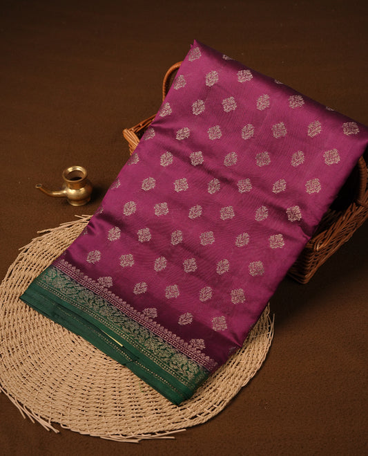 Purple colour pure tussar Banarasi saree featuring Gold zari motifs on body, contrast green colour border, and blouse piece.