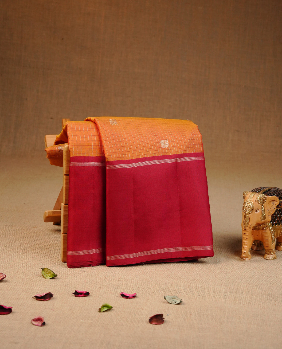 Mustard colour traditional kancheepuram silk saree featuring Golf zari check with peacock buttas on body, complemented by contrast Maroon colour with simple zari border, comes with matching blouse piece.