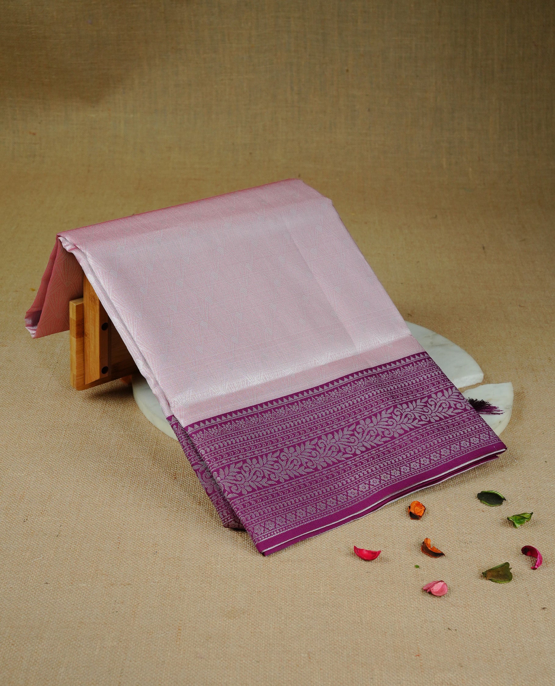 Baby pink colour semi silk saree featuring Silver zari Design pattern on body, complemented by contrast Purple colour with silver zari border, comes with matching blouse piece
