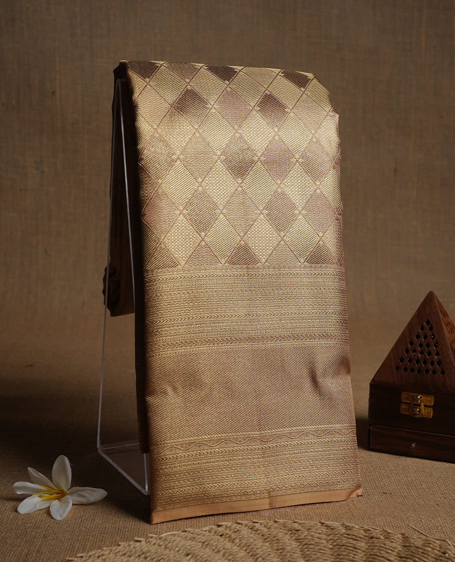 Gold colour kancheepuram tissue silk saree highlighting gold Geometric zari pattern body, with contrast traditional border and paired with matching blouse.