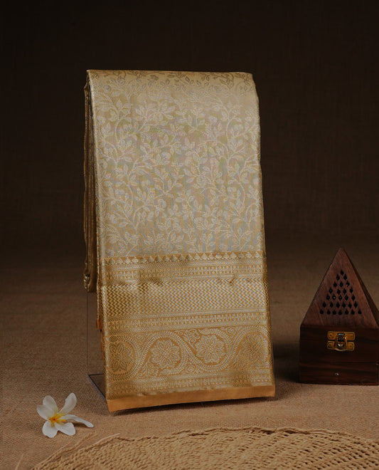 Golden Cream colour Semi Tissue silk saree featuring Gold zari kodi pattern on body, complemented by traditional border with self colour, paired with matching blouse piece.