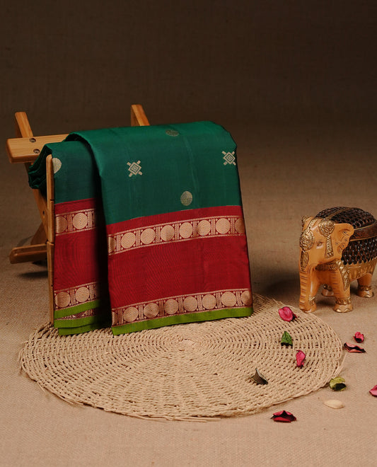 Green colour Traditional Kancheepuram silk saree featuring gold zari motifs on body, enhanced with contrast Red with traditional with Olive piping border, paired with matching blouse piece.