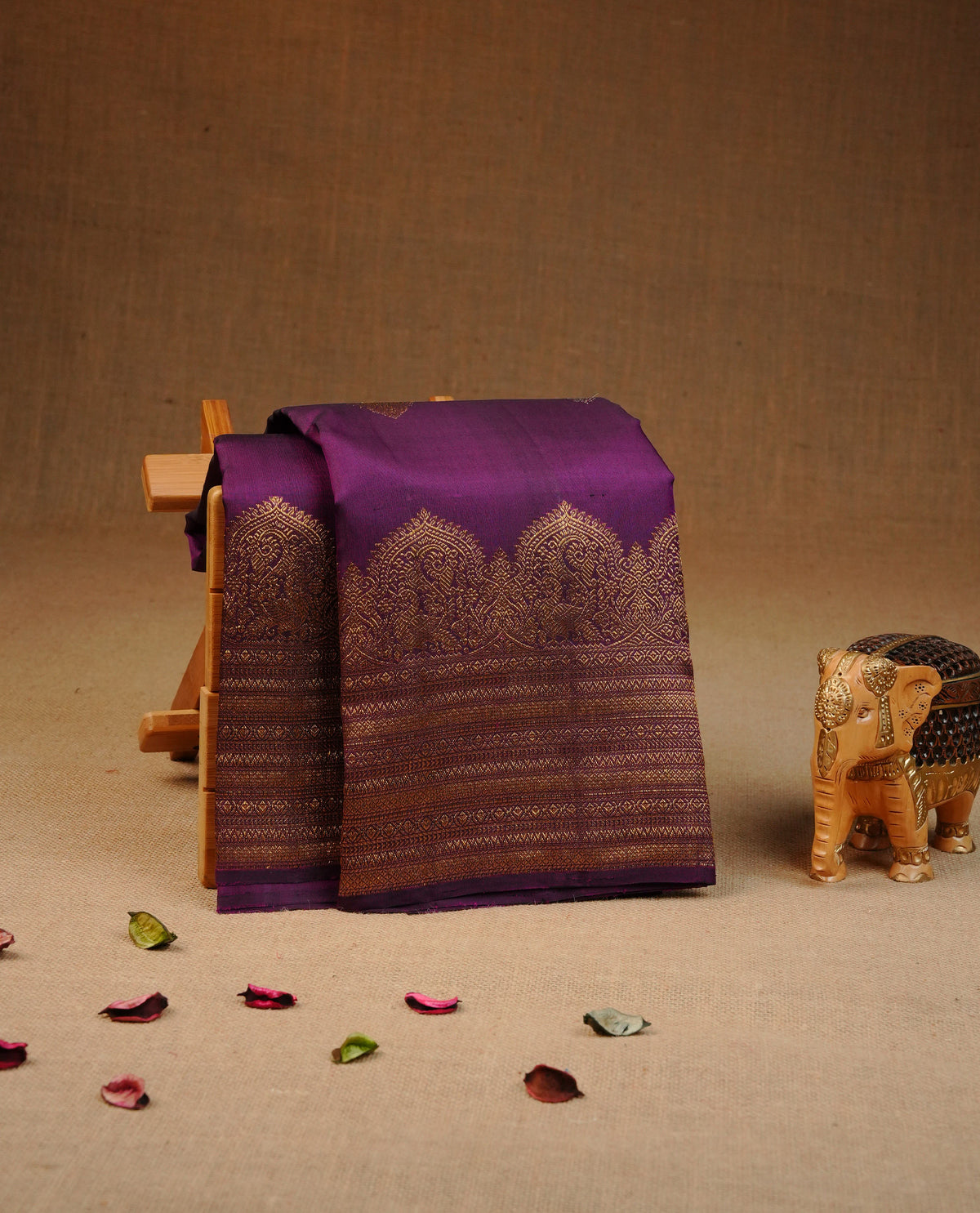 Deep purple colour Traditional kancheepuram silk saree featuring gold & silver zari motifs on body, complemented by self colour with traditional border, comes with matching blouse piece.